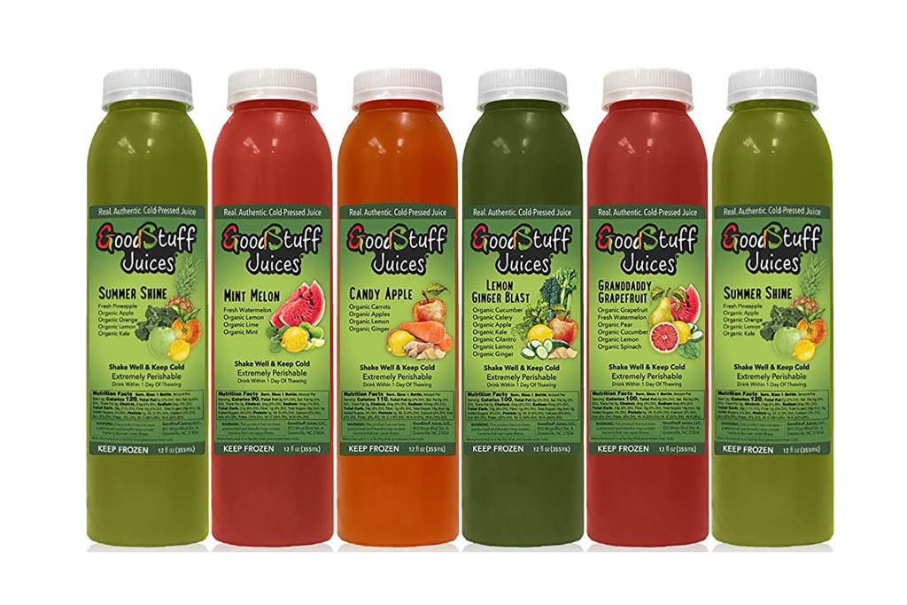 An array of vegetable juices in green bottles 